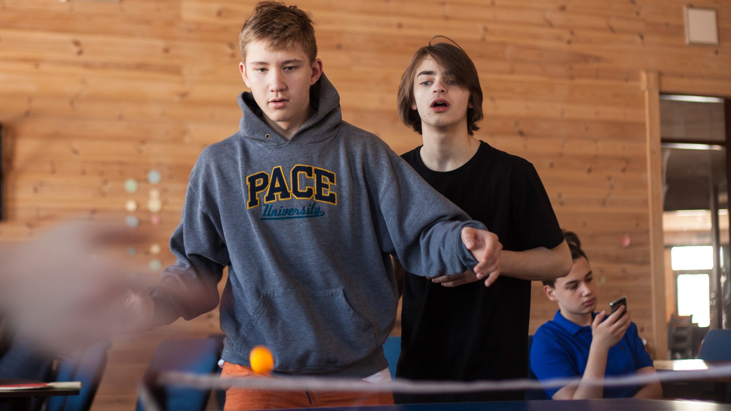 Two boys playing table tennis